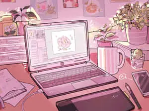 a laptop on a desk with a flower on it