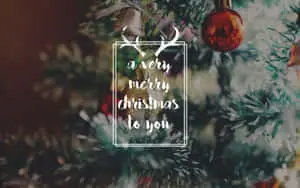 Celebrate Christmas with a computer screen covered in festive decorations.