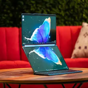 a laptop with a butterfly on it sitting on a table