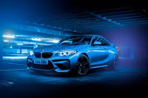 Glowing Blue BMW In A Parking Lot