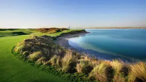 A scenic view of a golf course lined with lush green trees, perfect for a relaxing and enjoyable day of golf.