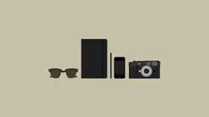 a camera, sunglasses, and a book on a beige background