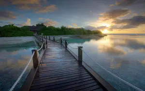 Stunning Sunset on Wooden Bridge Over Blue Sea