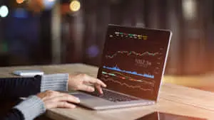 a person is using a laptop with a graph on it